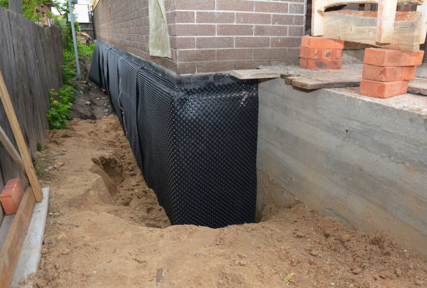 Happy homeowners after waterproofing job in Tekonsha